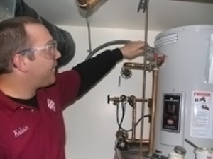 one of our Orange CA plumbers is checking the thermostat