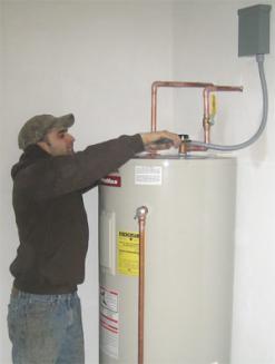 one of our plumbers is working on a water heater